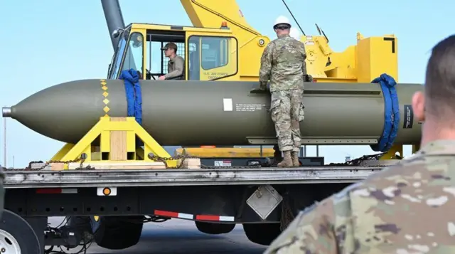 American military personnel handling a mass penetration pump (MOP) placed on a truck